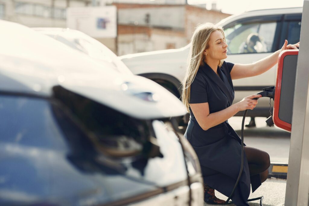 Sieviete liek savu elektroauto lādēties